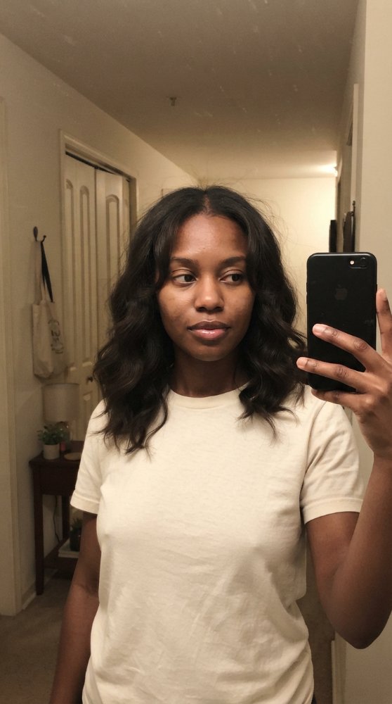 The hair visible in this is dark brown in color, with a medium length that falls just below the shoulders.