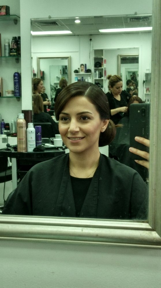 The hair visible in the is dark brown, cut into a short style with a sleek, smooth texture