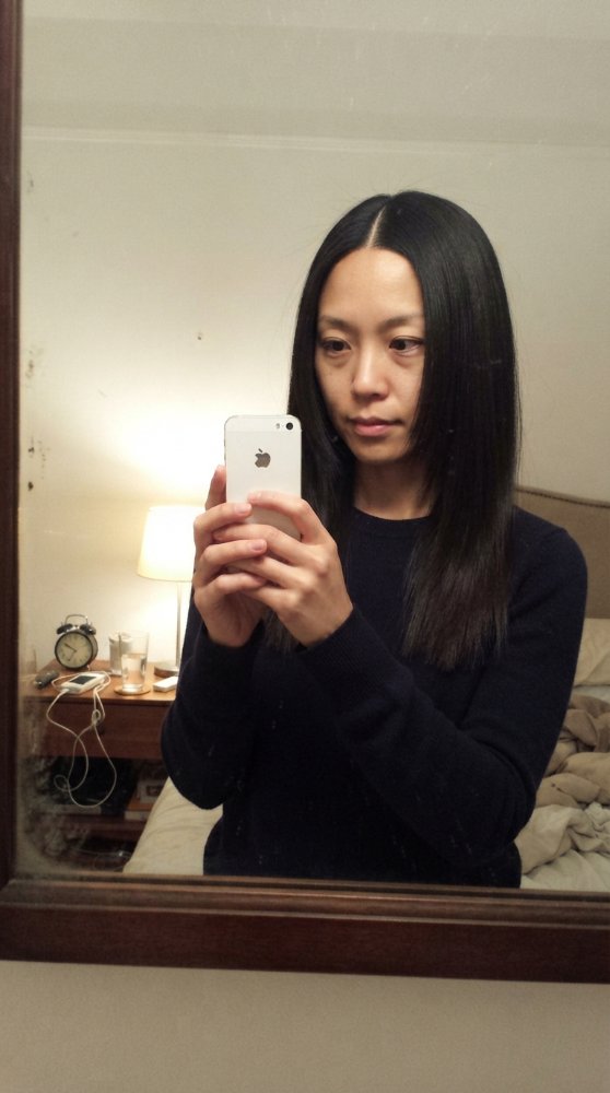 The hair visible in the is dark in color, straight in texture, and reaches a considerable length that falls below the shoulders
