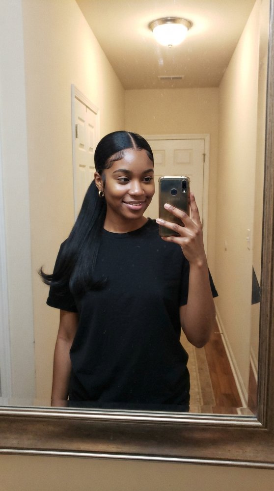 The hair visible in the is long, straight, and black, with a smooth texture that is sleek and polished